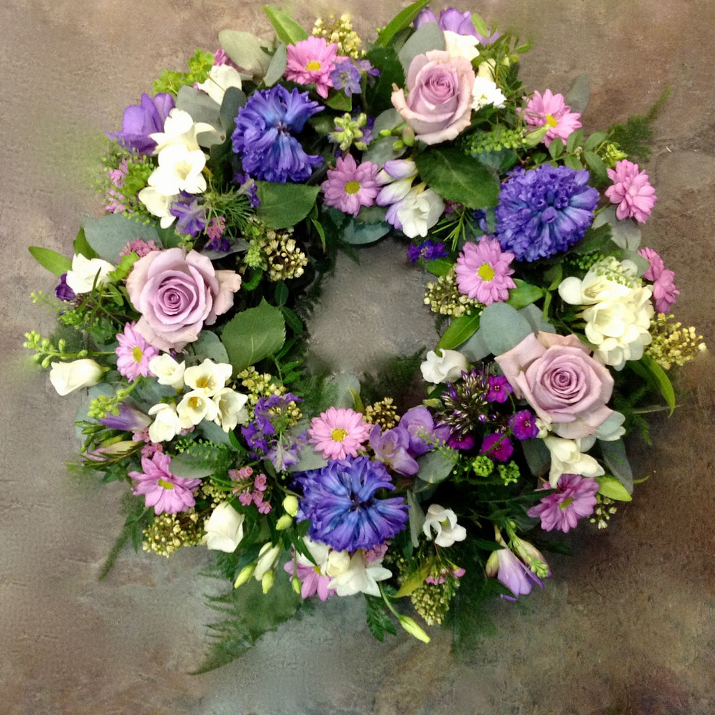 Lilac roses with pink and purple flower funeral wreath
