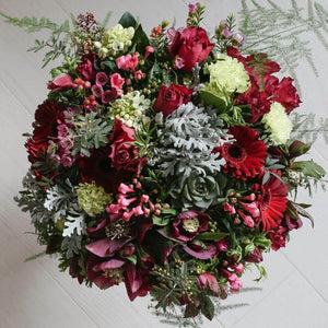 Rich red roses and lime carnations in a bouquet