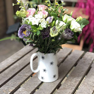 a blossom design jug filled with seasonal flowers