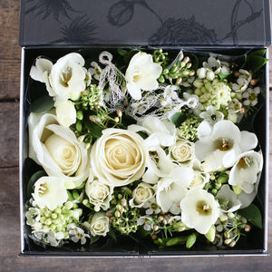 cream roses and white freesia with pale green berry foliage