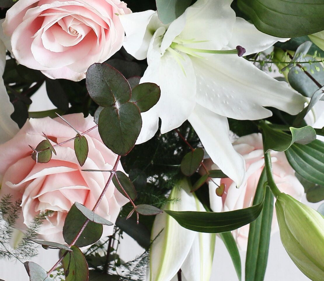 Pale pink roses and while lilies and foliage.