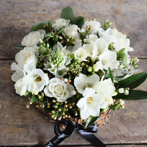 white roses, freesia and hypericum foliage