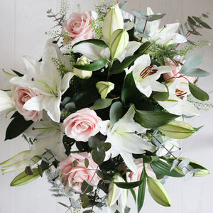 Pink roses and white lilies.