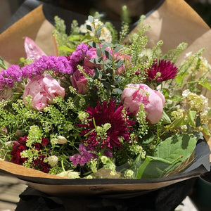 A selection of seasonal flowers and foliage wrapped in Sarah Horne paper