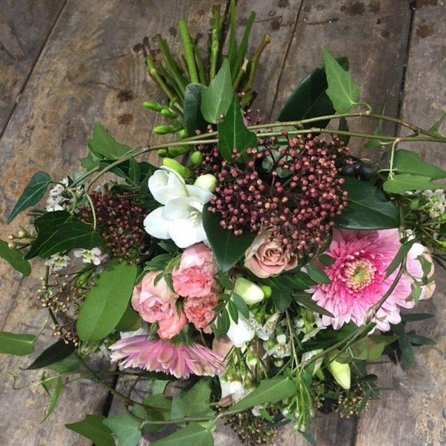 pink germini and roses with foliage bridal bouquet