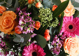 Orange Cerise and lilac flowers in a gift box.