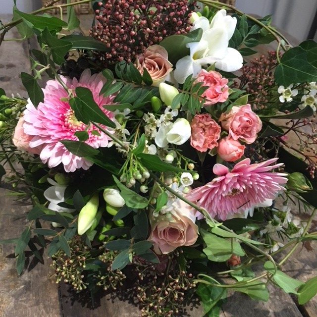 pink germini and roses with foliage bridal bouquet