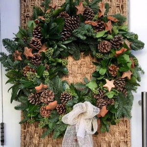 Christmas door garland/wreath with pinecones and star shapes