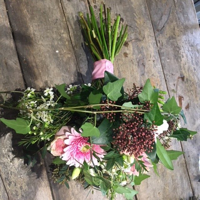 pink germini and roses with foliage bridal bouquet