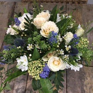 white and blue flowers in a bridal bouquet