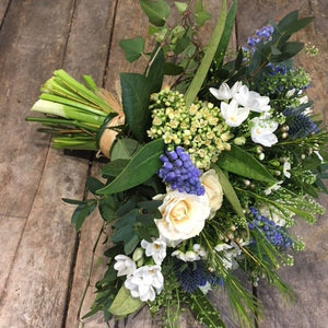 white and blue flowers in a bridal bouquet