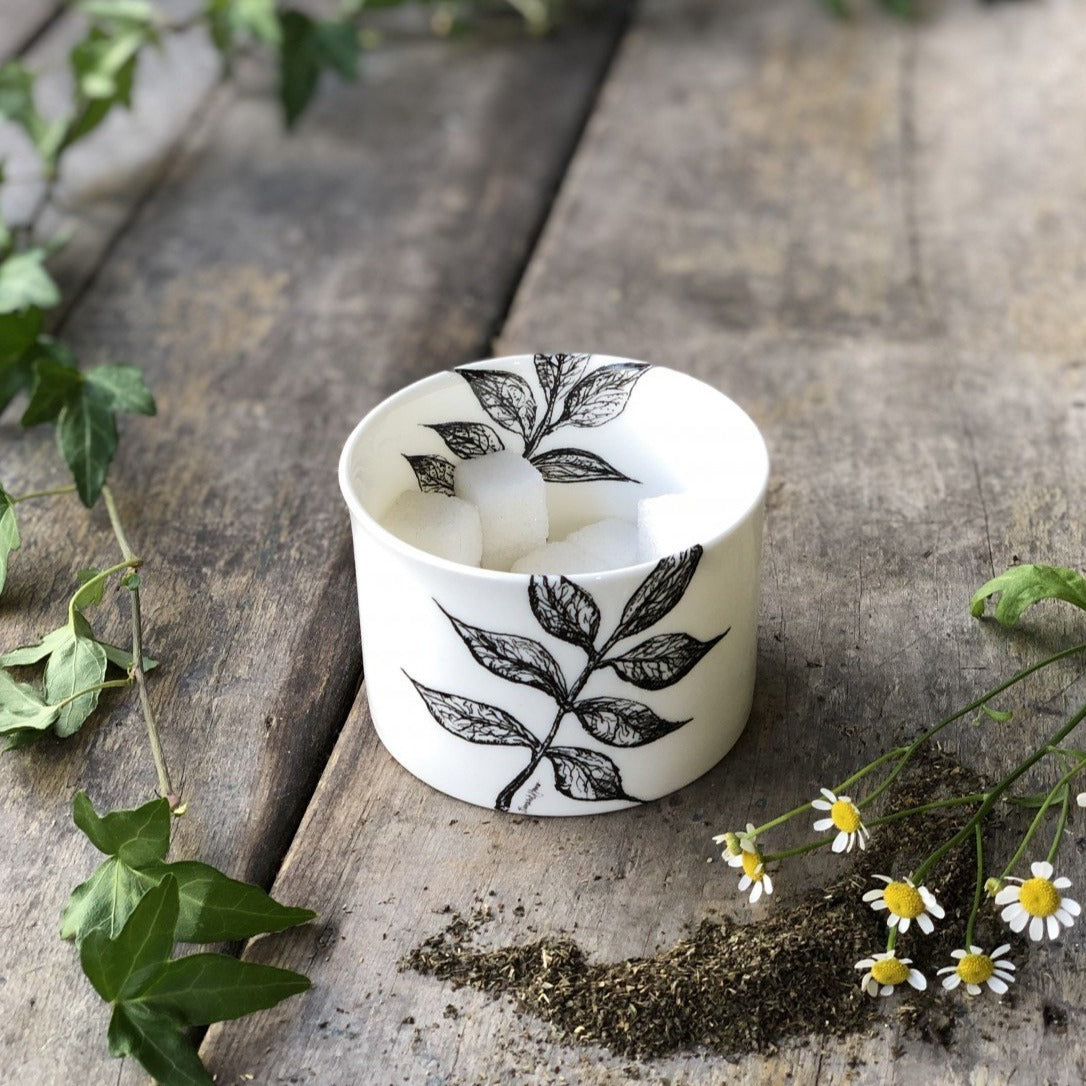 A sugar bowl decorated with leaf design