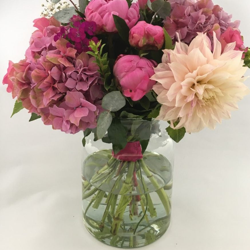 eco vase made with recycled glass shown with flowers