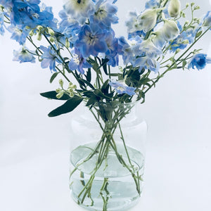 eco vase made with recycled glass shown with flowers