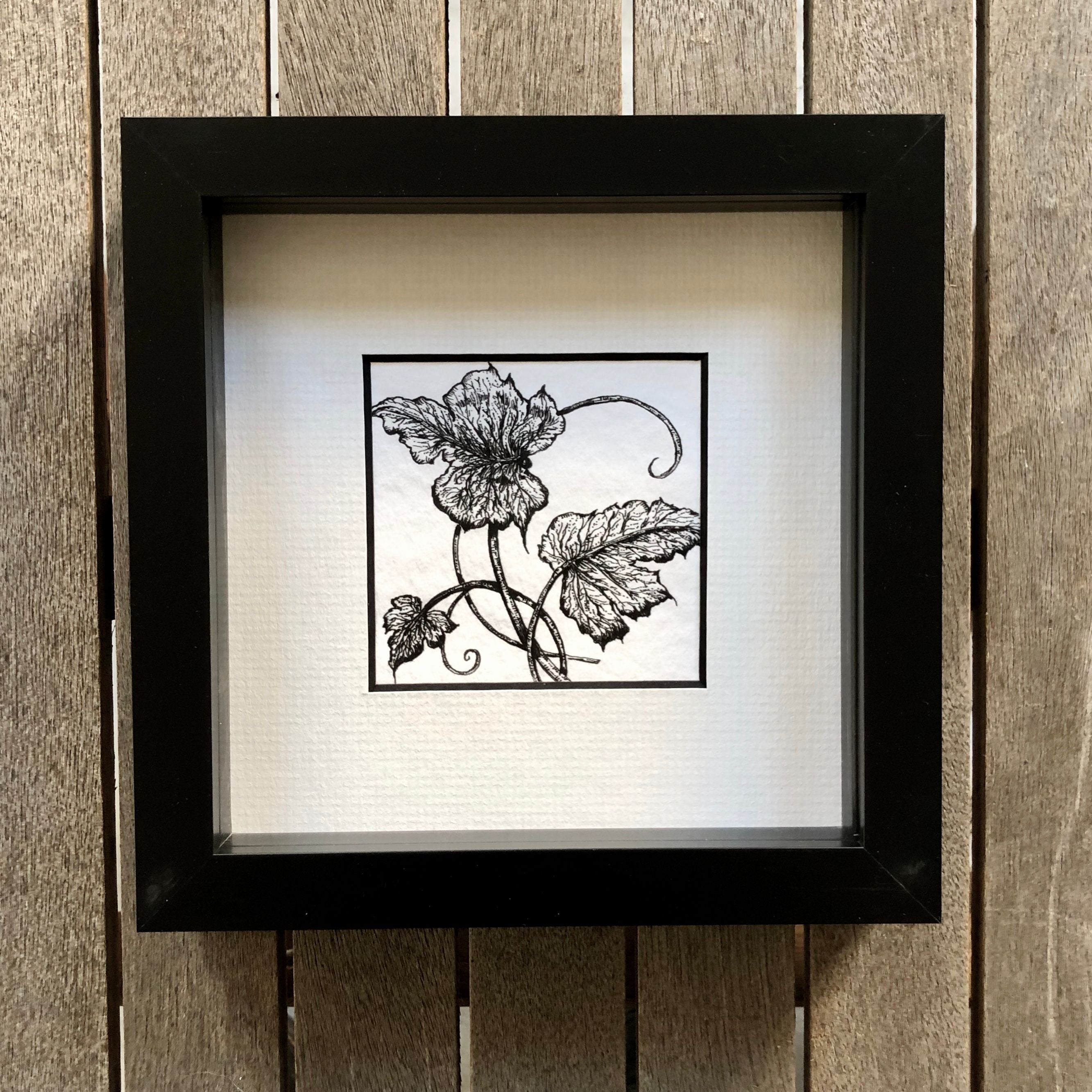 Detailed illustration of ivy leaves in a modern black frame