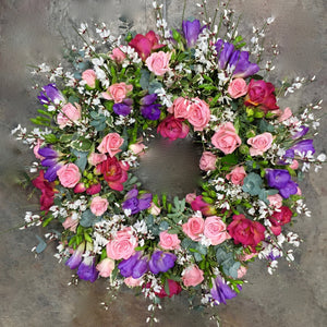 pink spray roses and lilac and red freesia funeral wreath