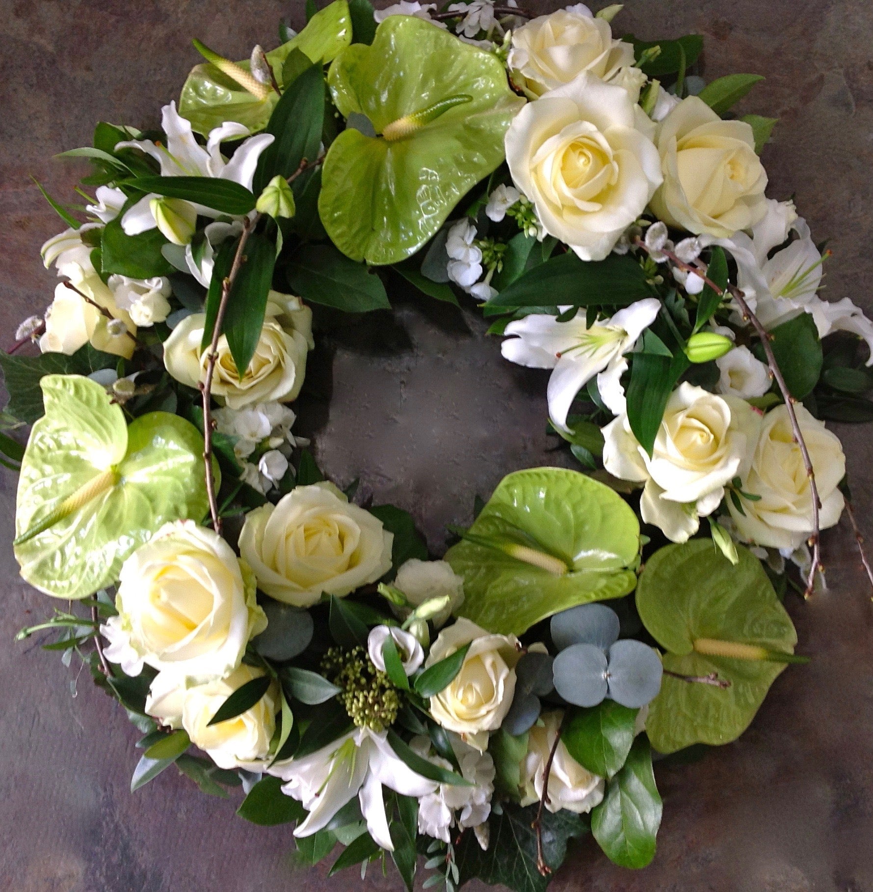 Roses, anthurium and lilies funeral wreath