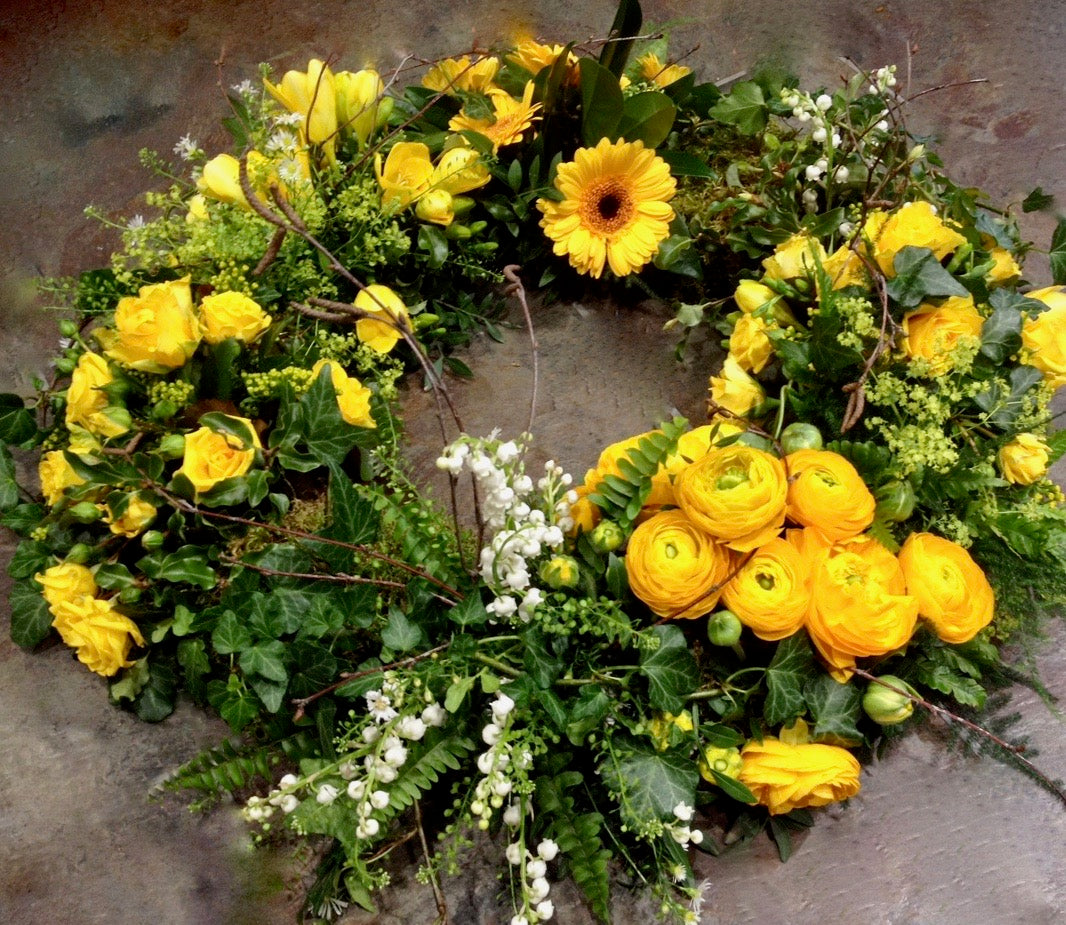 yellow roses, germini, ranunculus in a group style wreath