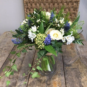 white and blue flowers in a bridal bouquet