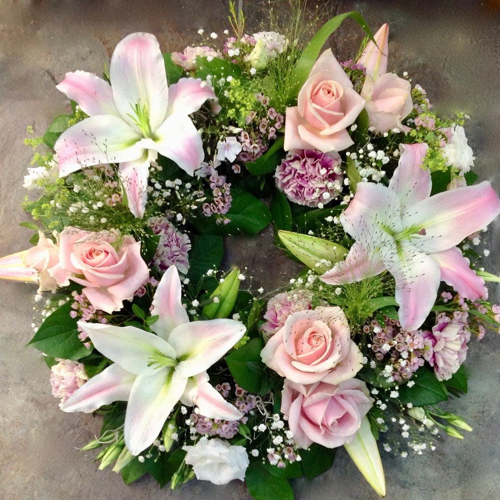 Pink Rose and lily funeral wreath.
