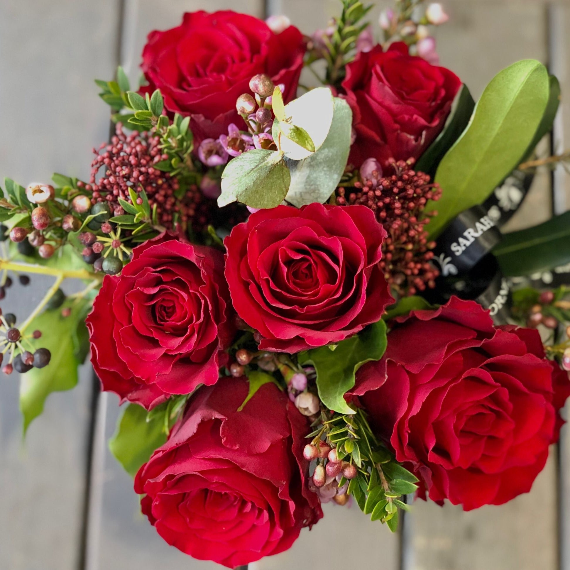 6 red roses in a cube vase