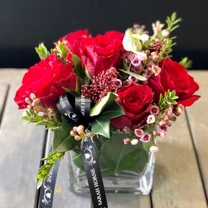 6 red roses in a cube vase 